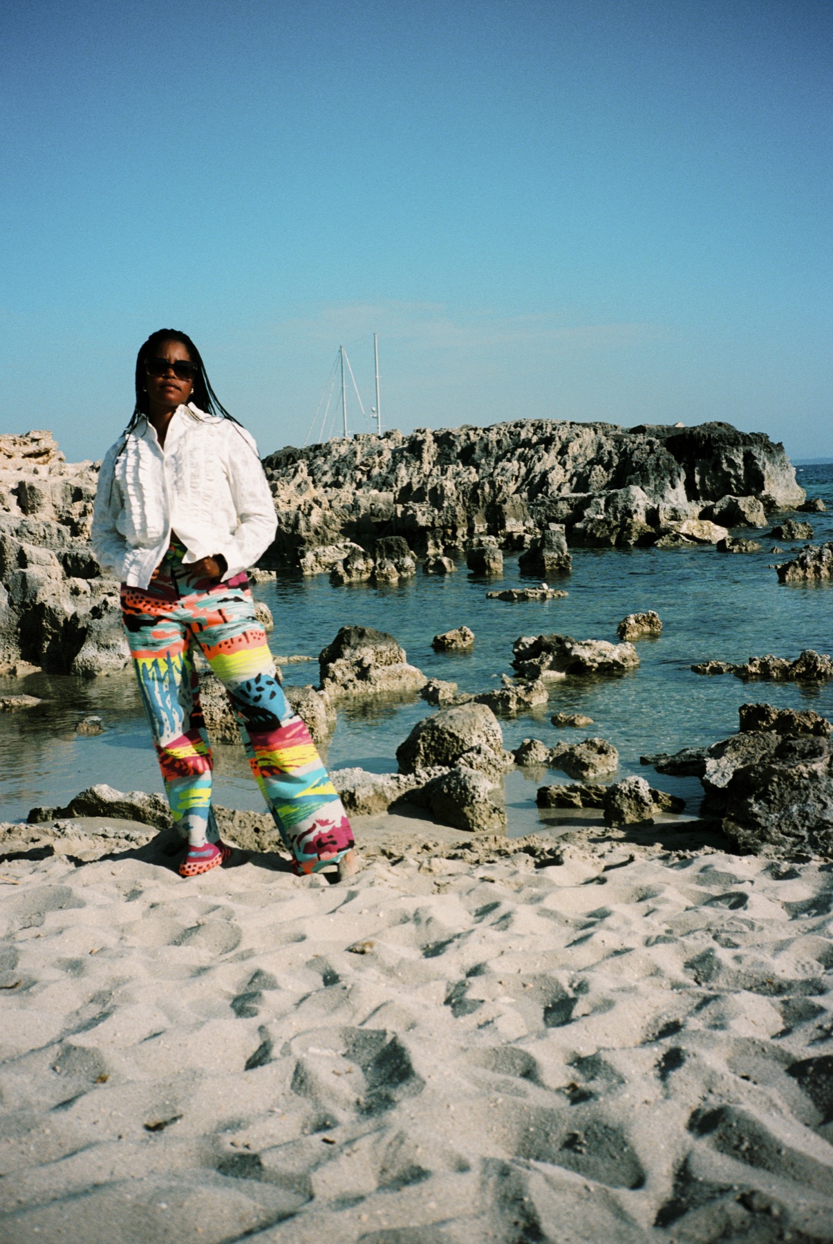 Scan 08 — landscape trousers at rocky shore, open sky