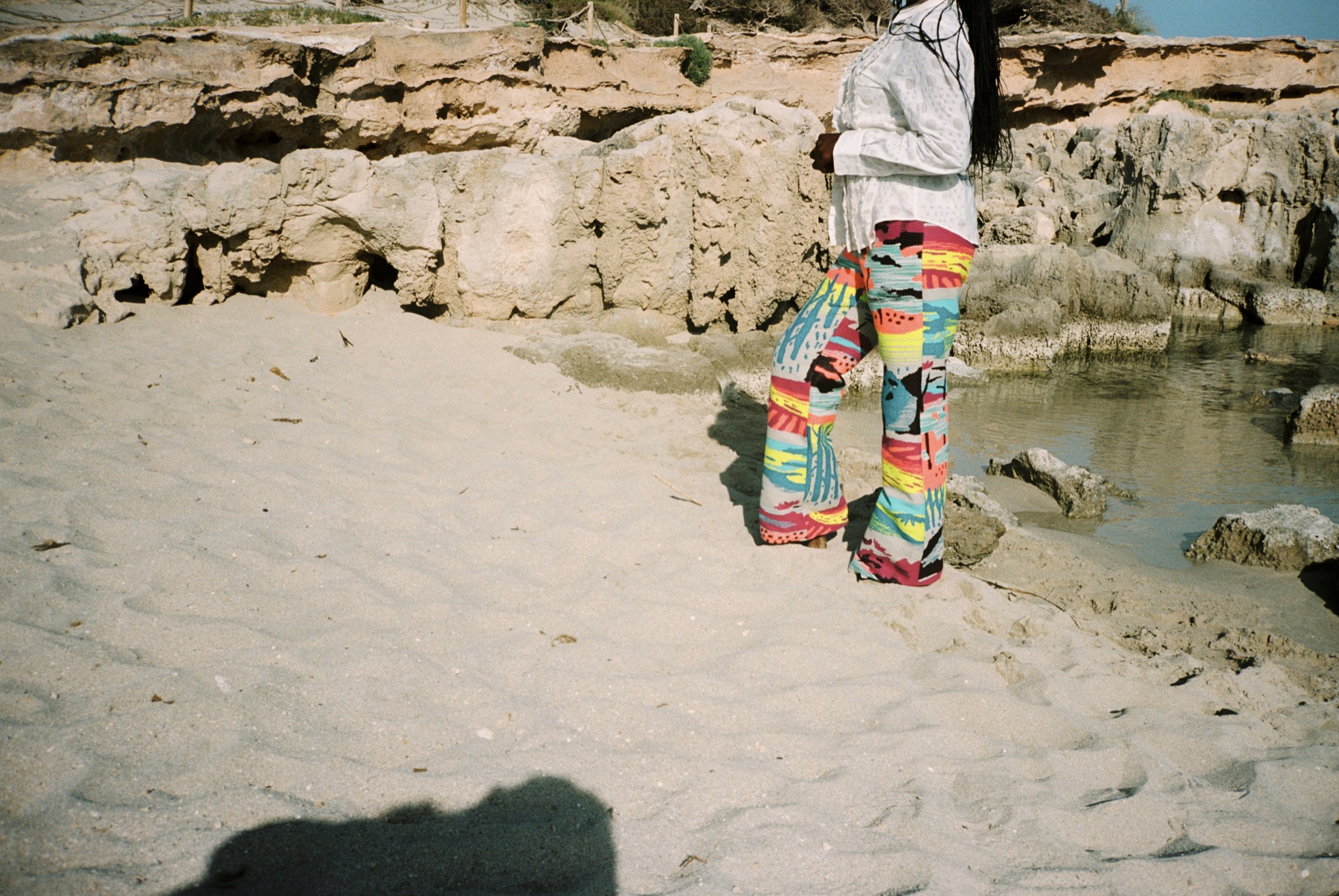 Scan 11 — landscape trousers, limestone pool and sand