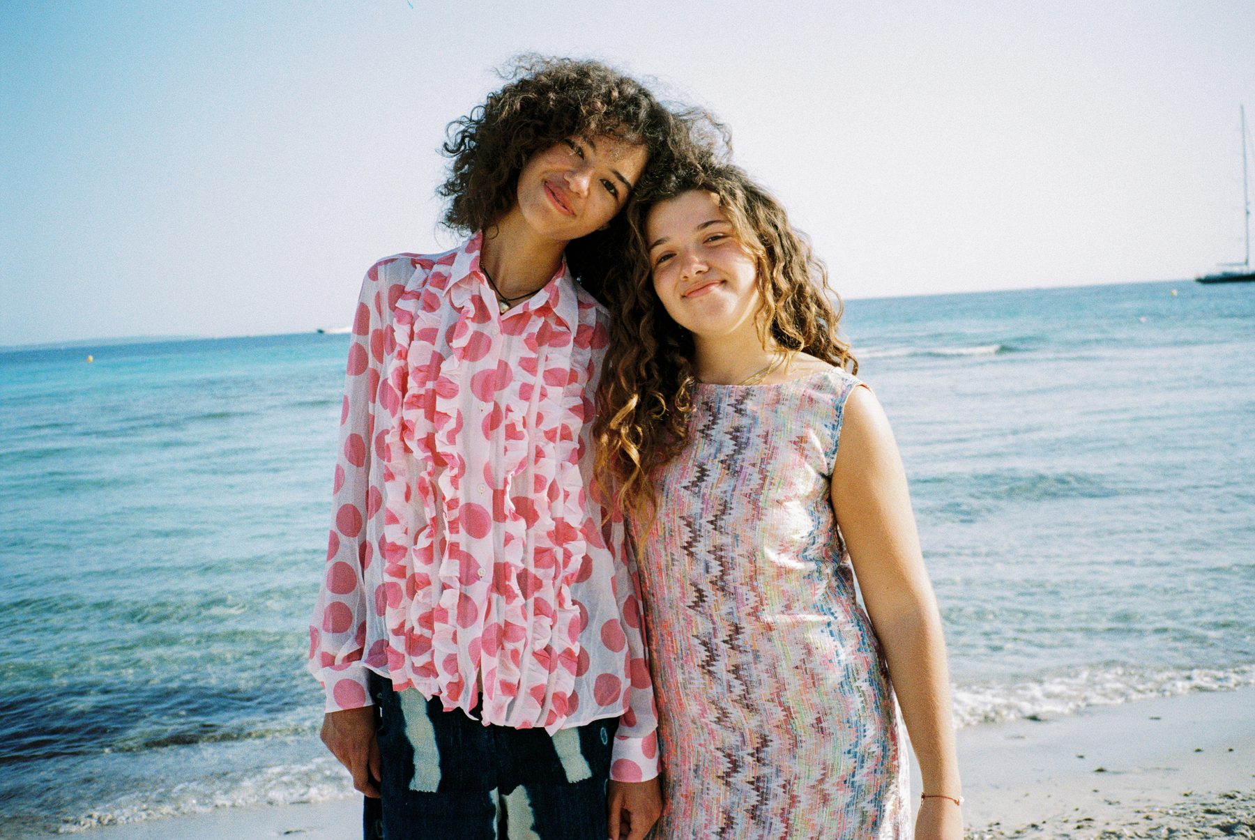 Scan 19 — polka ruffle shirt and zigzag lamé shift at the water line